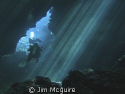 Divers exiting the cave that leads to Mirror Pond (one of... by Jim Mcguire 